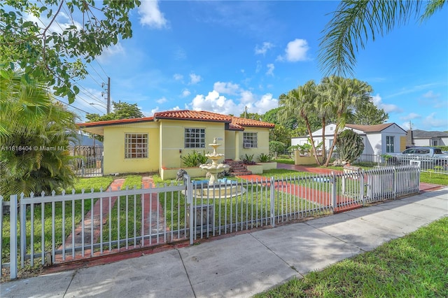 6561 SW 18th St, West Miami, FL 33155 - mediterranean / spanish-style home with stucco siding, a fenced front yard, and a tile roof