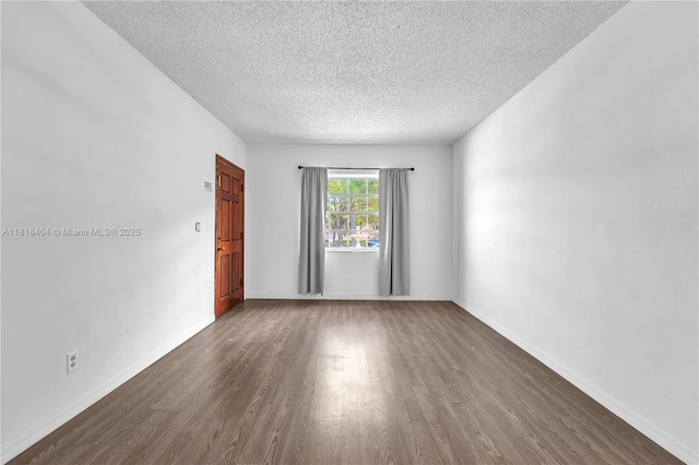 6561 SW 18th St, West Miami, FL 33155 - unfurnished room with a textured ceiling and wood finished floors