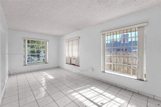 6561 SW 18th St, West Miami, FL 33155 - unfurnished room featuring a textured ceiling, tile patterned floors, and cooling unit