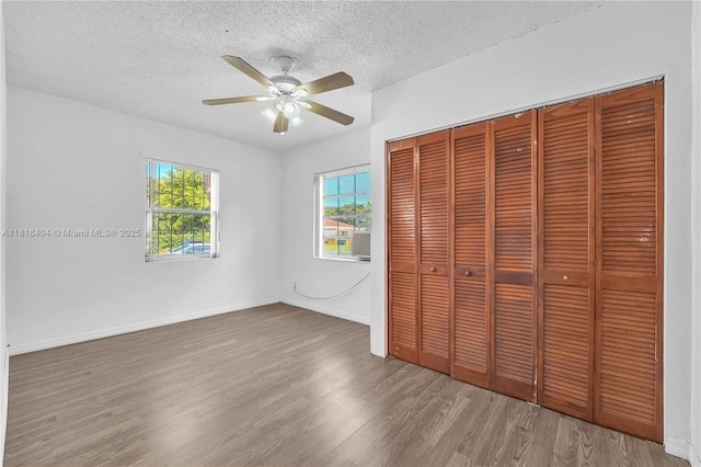 6561 SW 18th St, West Miami, FL 33155 - unfurnished bedroom featuring a textured ceiling, wood finished floors, a closet, and ceiling fan