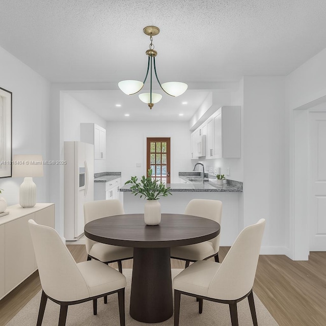 6561 SW 18th St, West Miami, FL 33155 - dining room featuring light wood-type flooring, recessed lighting, and a textured ceiling