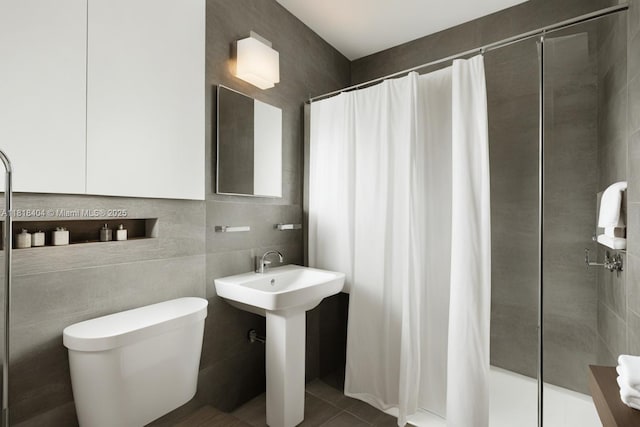 6561 SW 18th St, West Miami, FL 33155 - bathroom featuring a stall shower, tile walls, and tile patterned floors