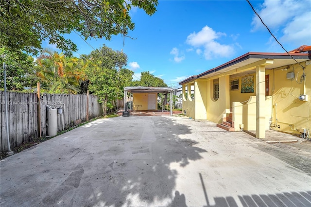 6561 SW 18th St, West Miami, FL 33155 - view of patio / terrace featuring a detached carport and driveway