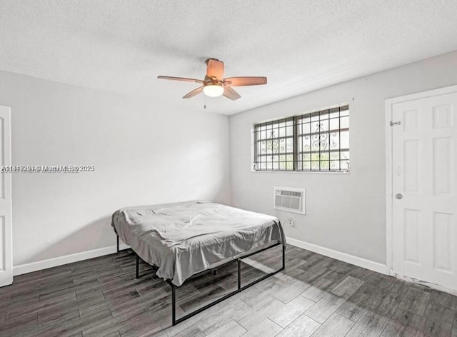 533 Meridian Ave Unit 11, Miami Beach, FL 33139 - bedroom featuring wood finished floors, a textured ceiling, an AC wall unit, and ceiling fan