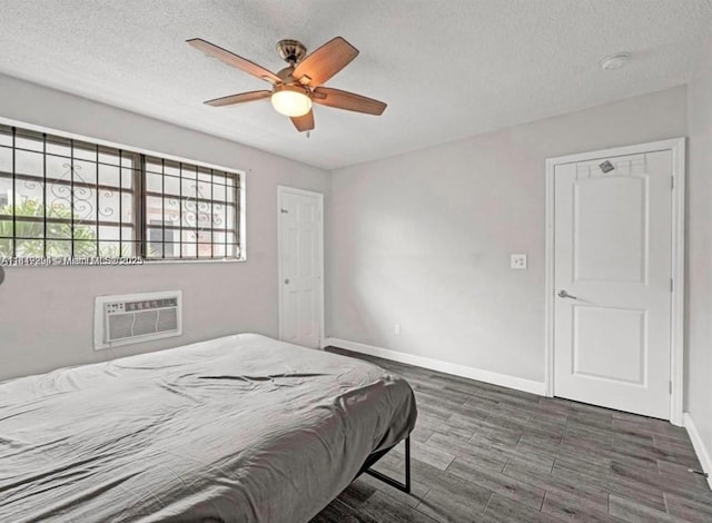 533 Meridian Ave Unit 11, Miami Beach, FL 33139 - bedroom featuring a wall unit AC, a textured ceiling, wood finished floors, and ceiling fan