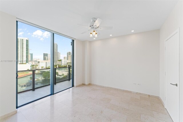 88 SW 7th St Unit 712, Miami, FL 33130 - empty room with a ceiling fan, a skyline view, floor to ceiling windows, and recessed lighting