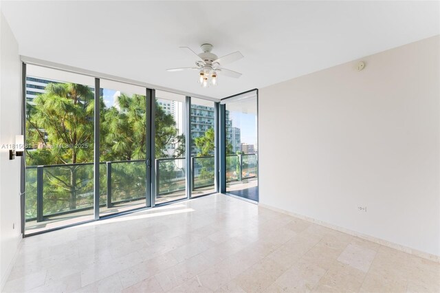 88 SW 7th St Unit 712, Miami, FL 33130 - spare room featuring expansive windows, ceiling fan, plenty of natural light, and a city view