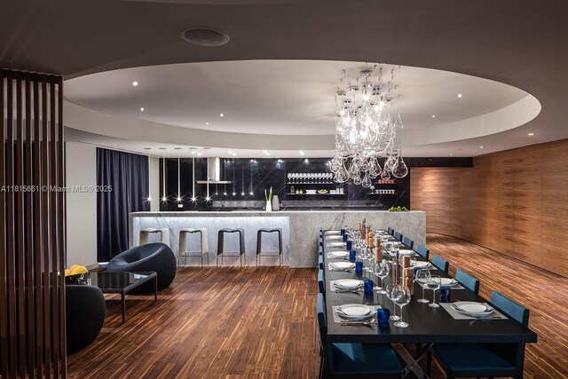 88 SW 7th St Unit 712, Miami, FL 33130 - dining area with wood finished floors, a community bar, and a chandelier