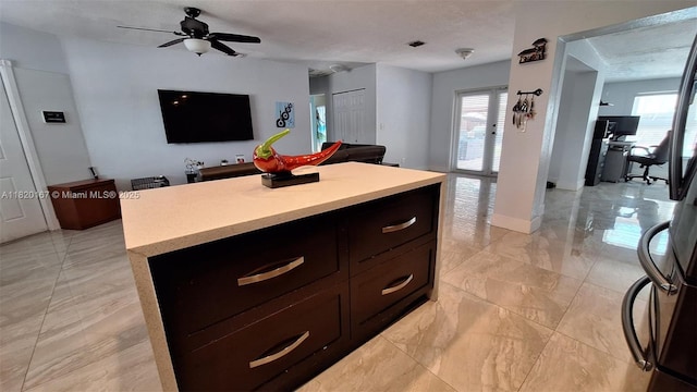 6810 Douglas St, Hollywood, FL 33024 - kitchen with light countertops, a kitchen island, healthy amount of natural light, and open floor plan