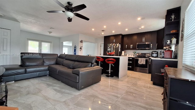 6810 Douglas St, Hollywood, FL 33024 - living room with plenty of natural light, a ceiling fan, and light marble finish floors