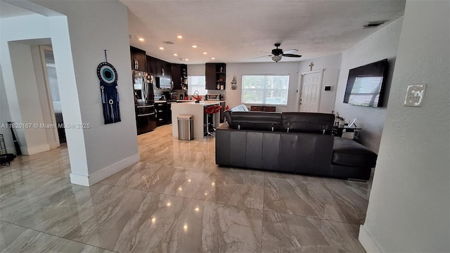 6810 Douglas St, Hollywood, FL 33024 - living area featuring ceiling fan, light marble finish floors, recessed lighting, and a textured wall