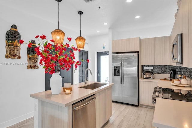 4740 NW 84th Ct Unit 38, Doral, FL 33166 - kitchen featuring stainless steel appliances, light countertops, light wood-style floors, modern cabinets, and recessed lighting