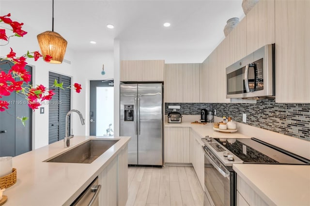 4740 NW 84th Ct Unit 38, Doral, FL 33166 - kitchen featuring stainless steel appliances, light countertops, modern cabinets, decorative light fixtures, and recessed lighting