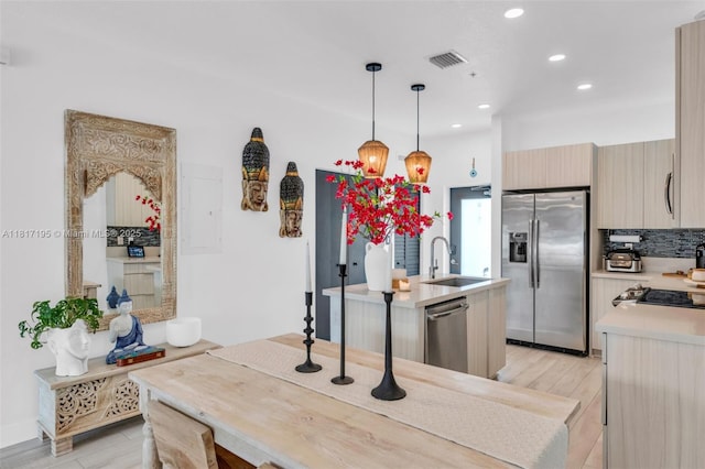 4740 NW 84th Ct Unit 38, Doral, FL 33166 - kitchen featuring appliances with stainless steel finishes, light countertops, recessed lighting, light wood-style flooring, and decorative light fixtures