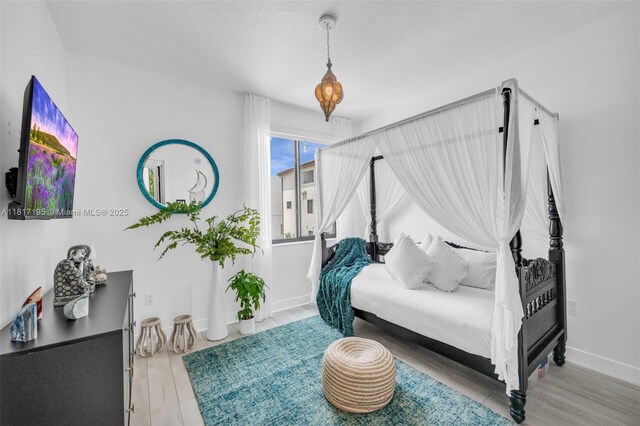 4740 NW 84th Ct Unit 38, Doral, FL 33166 - bedroom with wood finished floors and baseboards