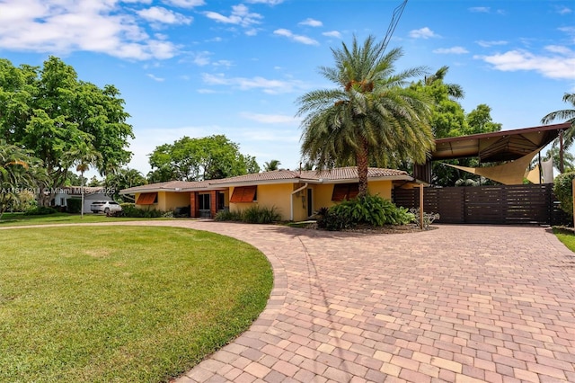 901 W Tropical Way, Plantation, FL 33317 - single story home with curved driveway, stucco siding, a gate, and a tiled roof