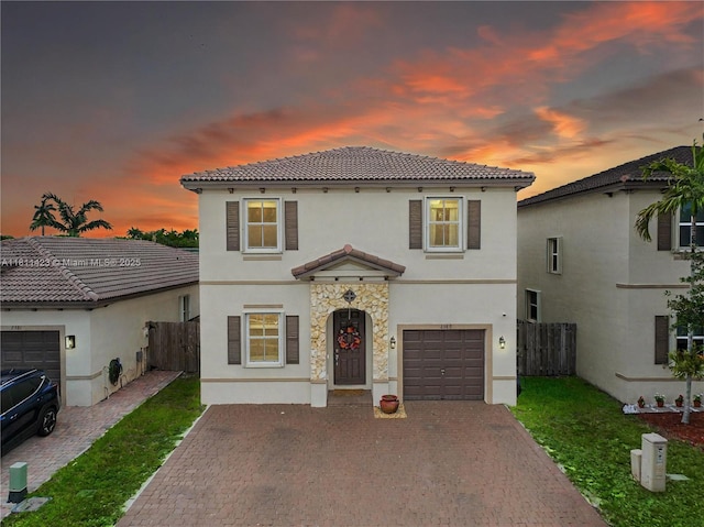 2389 NE 4th St, Homestead, FL 33033 - mediterranean / spanish home featuring stucco siding, decorative driveway, a tiled roof, and a garage