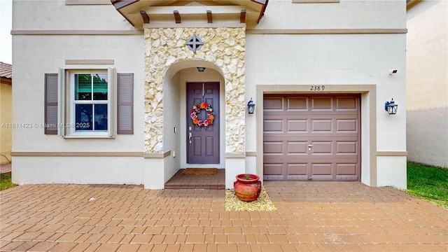 2389 NE 4th St, Homestead, FL 33033 - property entrance with stone siding, stucco siding, and decorative driveway
