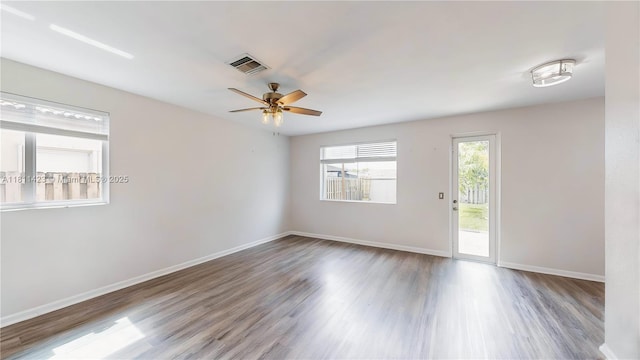 2389 NE 4th St, Homestead, FL 33033 - empty room with wood finished floors and a ceiling fan
