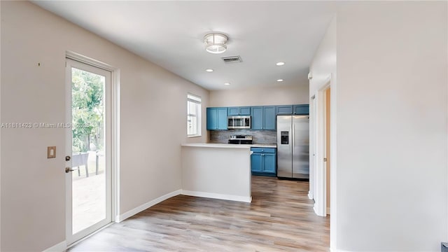 2389 NE 4th St, Homestead, FL 33033 - kitchen featuring stainless steel appliances, blue cabinets, healthy amount of natural light, light wood-style flooring, and recessed lighting