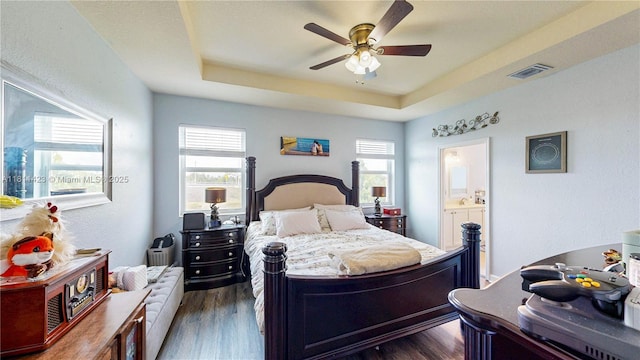 2389 NE 4th St, Homestead, FL 33033 - bedroom with a raised ceiling, dark wood-style flooring, connected bathroom, and ceiling fan