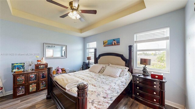 2389 NE 4th St, Homestead, FL 33033 - bedroom featuring a raised ceiling, dark wood-style flooring, and a ceiling fan
