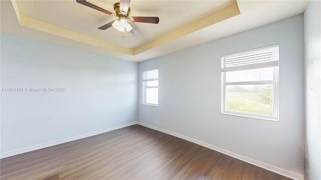 2389 NE 4th St, Homestead, FL 33033 - unfurnished room featuring a raised ceiling, dark wood-style floors, and a ceiling fan