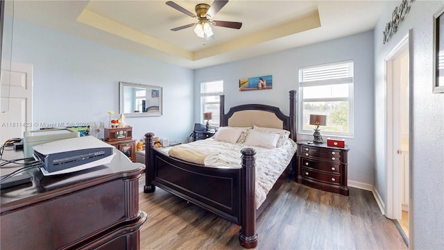 2389 NE 4th St, Homestead, FL 33033 - bedroom with a tray ceiling, dark wood-style floors, and a ceiling fan