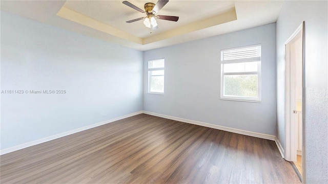 2389 NE 4th St, Homestead, FL 33033 - unfurnished bedroom featuring wood finished floors, a raised ceiling, and a ceiling fan