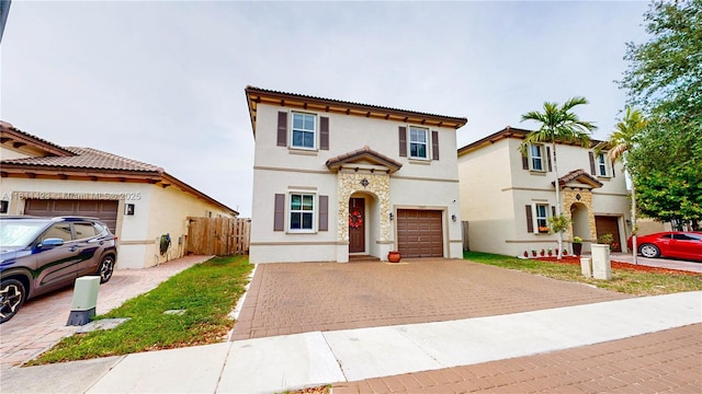 2389 NE 4th St, Homestead, FL 33033 - mediterranean / spanish home featuring decorative driveway, stucco siding, an attached garage, and a tiled roof