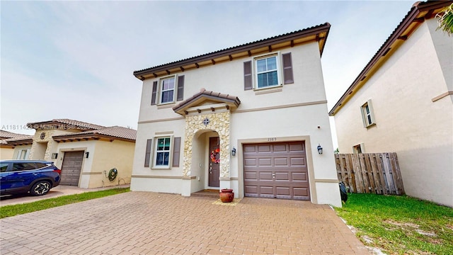 2389 NE 4th St, Homestead, FL 33033 - mediterranean / spanish house featuring decorative driveway, stucco siding, and an attached garage