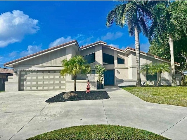 680 NW 111th Way, Coral Springs, FL 33071 - mid-century home with an attached garage, driveway, stucco siding, and a tiled roof