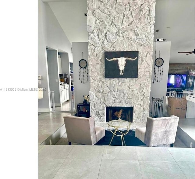 680 NW 111th Way, Coral Springs, FL 33071 - tiled living area with a stone fireplace, a ceiling fan, and lofted ceiling