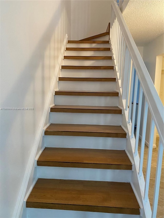 721 SE 1st Way Unit B18, Deerfield Beach, FL 33441 - stairs featuring a textured ceiling