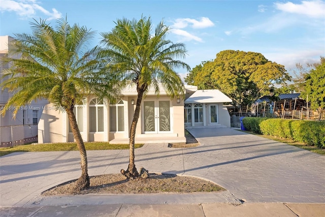 3421 SW 4th St, Miami, FL 33135 - single story home with curved driveway, stucco siding, and french doors