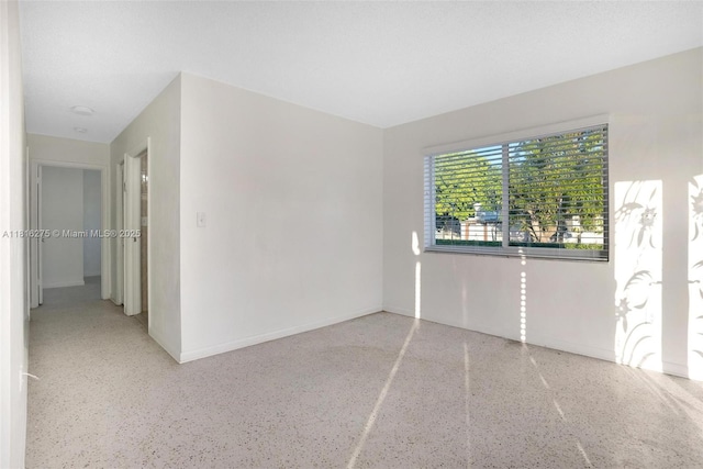 3421 SW 4th St, Miami, FL 33135 - unfurnished room featuring speckle patterned floor and baseboards