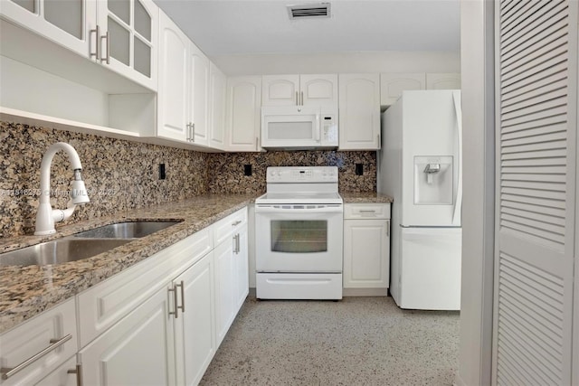 3421 SW 4th St, Miami, FL 33135 - kitchen with white appliances, light stone counters, glass insert cabinets, and white cabinets