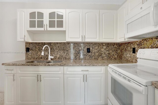 3421 SW 4th St, Miami, FL 33135 - kitchen with white appliances, tasteful backsplash, white cabinets, glass insert cabinets, and light stone counters