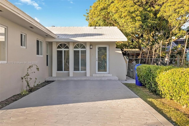 3421 SW 4th St, Miami, FL 33135 - view of exterior entry with stucco siding and a patio area