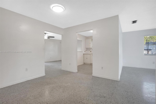 3421 SW 4th St, Miami, FL 33135 - spare room with a ceiling fan and dark speckled floor
