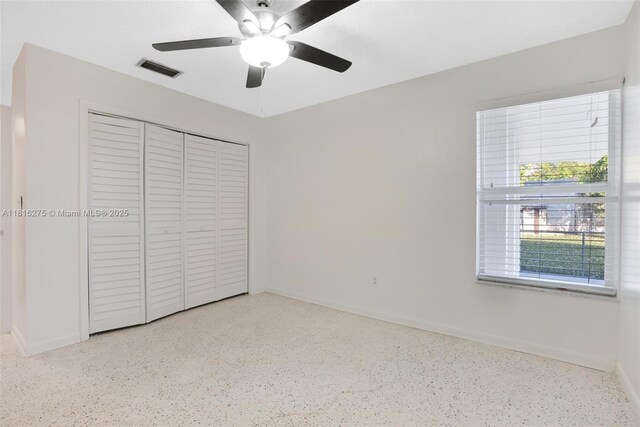 3421 SW 4th St, Miami, FL 33135 - unfurnished bedroom with speckled floor, a closet, and a ceiling fan