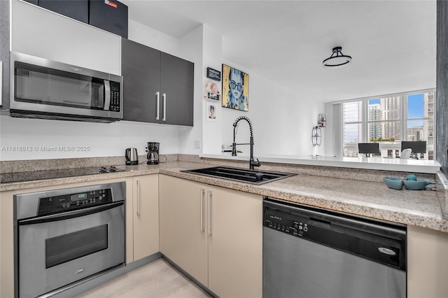 500 NE 29th St Unit 905, Miami, FL 33137 - kitchen with stainless steel appliances, light countertops, and a peninsula