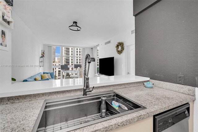 500 NE 29th St Unit 905, Miami, FL 33137 - kitchen featuring stainless steel dishwasher, open floor plan, and light countertops