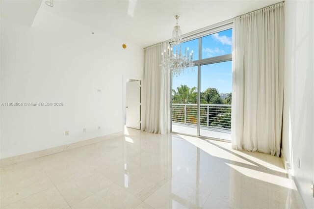 2001 Meridian Ave Unit 516, Miami Beach, FL 33139 - empty room featuring a chandelier and tile patterned flooring