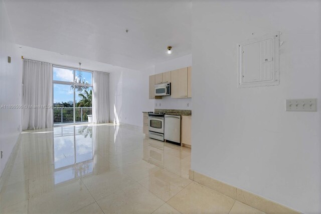 2001 Meridian Ave Unit 516, Miami Beach, FL 33139 - kitchen featuring appliances with stainless steel finishes, electric panel, light tile patterned flooring, and a chandelier