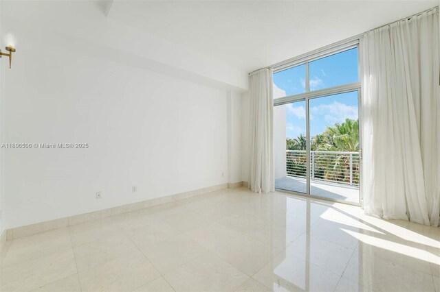 2001 Meridian Ave Unit 516, Miami Beach, FL 33139 - empty room featuring floor to ceiling windows and light tile patterned floors