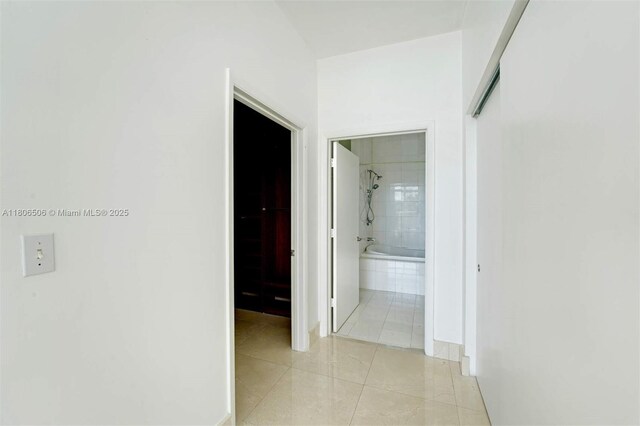 2001 Meridian Ave Unit 516, Miami Beach, FL 33139 - hallway featuring light tile patterned floors and baseboards