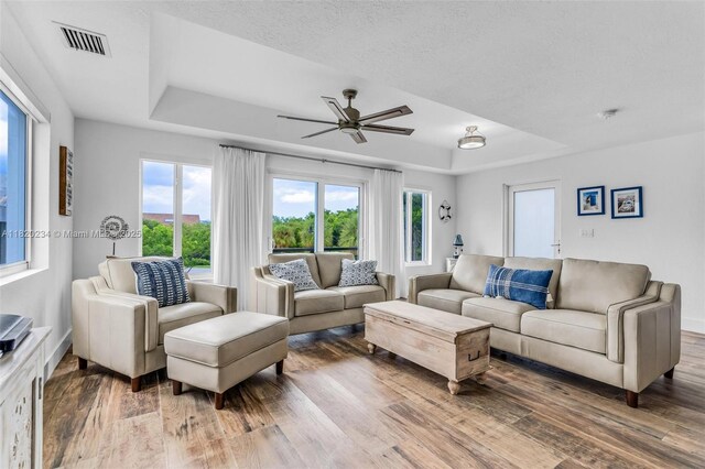 94825 Overseas Hwy, Key Largo, FL 33037 - living area featuring a raised ceiling, wood finished floors, and a ceiling fan