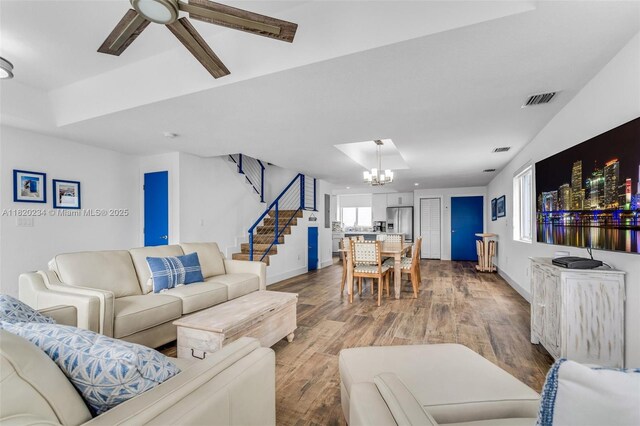 94825 Overseas Hwy, Key Largo, FL 33037 - living room featuring a chandelier, stairs, a ceiling fan, and wood finished floors