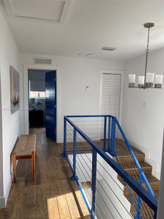 94825 Overseas Hwy, Key Largo, FL 33037 - corridor featuring wood-type flooring and an upstairs landing